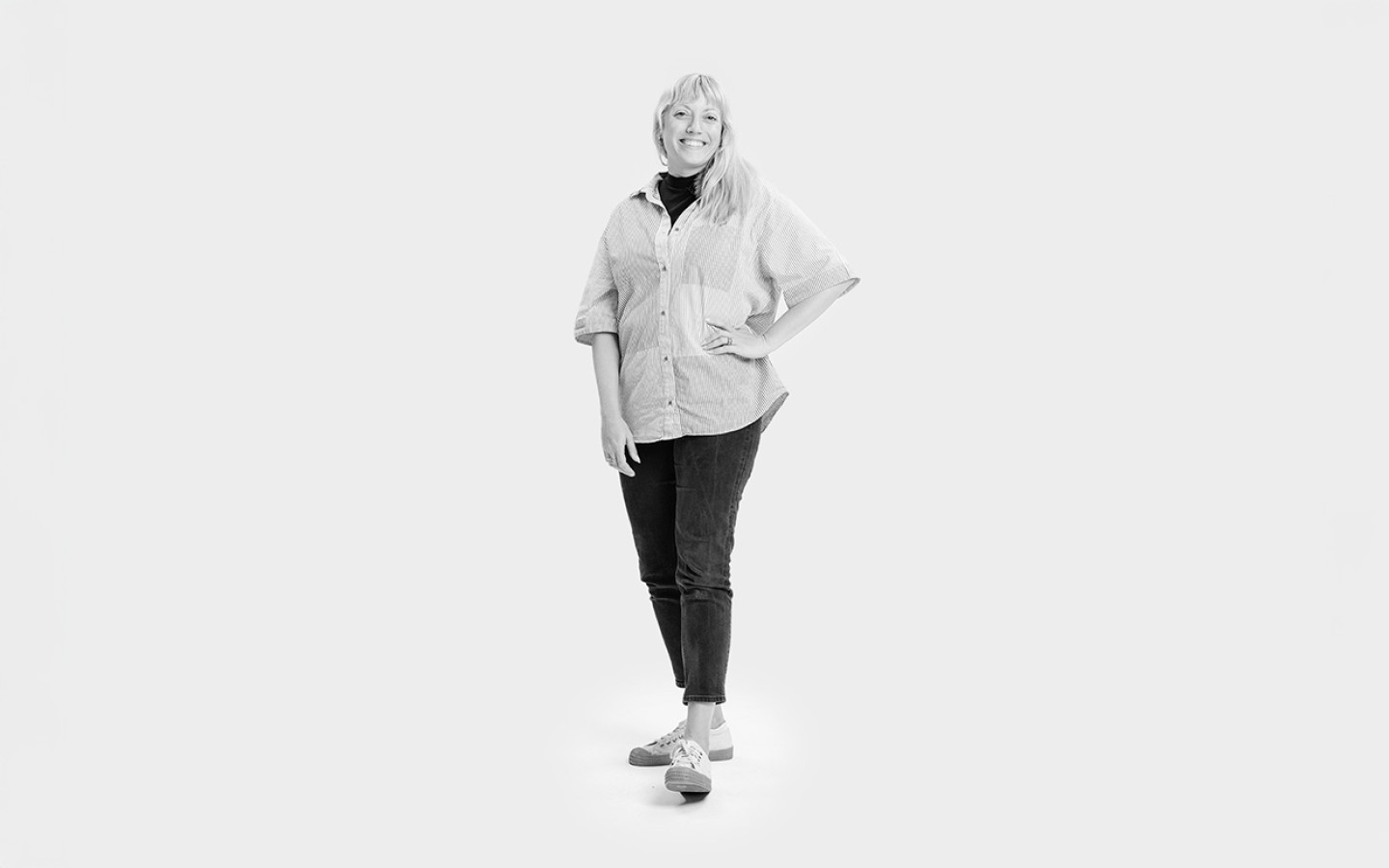 Image of woman in jeans and shirt who is our head of design.